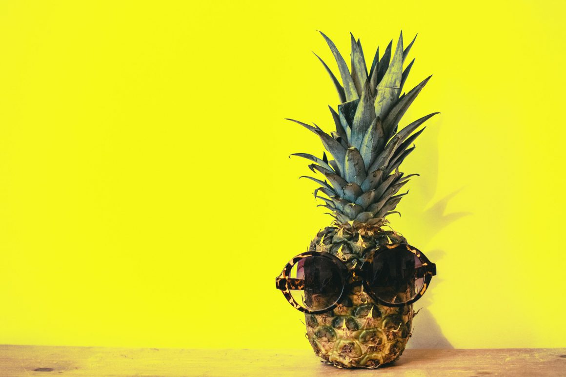 green pineapple fruit with brown framed sunglasses beside 1161547