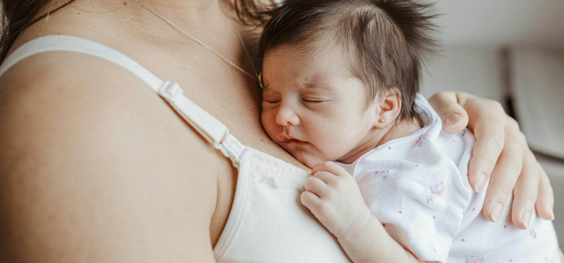 newborn baby won't stay latched on and cries