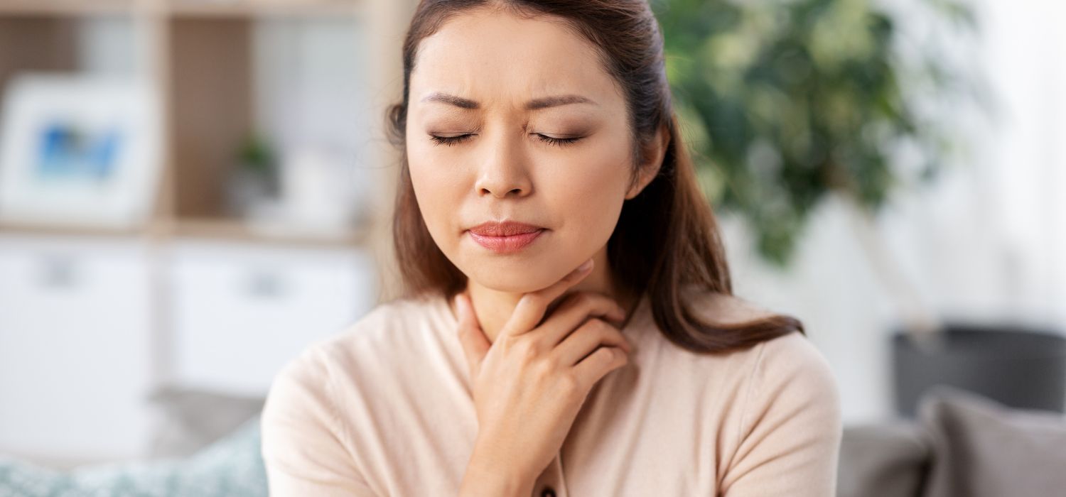 thyrotoxicosis with pregnancy asian woman touching neck